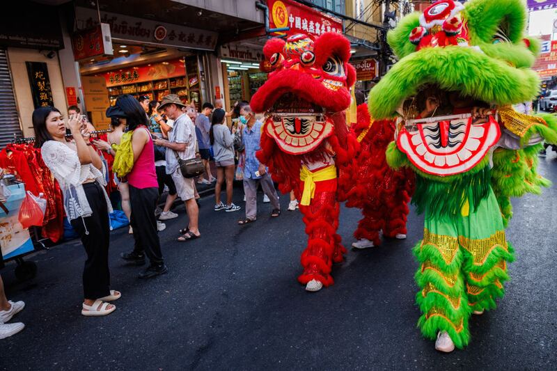 BANGKOK, THAILAND - FEBRUARY 09: A lion dance troupe performs on Yaowarat Road in Chinatown on Lunar New Years Eve on February 09, 2024 in Bangkok, Thailand. The Chinese diaspora of Southeast Asia celebrates a lively Lunar New Year in Bangkok's Chinatown. It is traditionally a time for people to meet their relatives and take part in celebrations with families. In Thailand, which has a sizeable population of Chinese lineage, people gather with family and celebrate with feasts and visits to temples. The Tourism Authority of Thailand is expecting a steep increase in tourism during the Lunar New Year now that visa free travel is permmited for Chinese citizens to Thailand. (Photo by Lauren DeCicca/Getty Images)