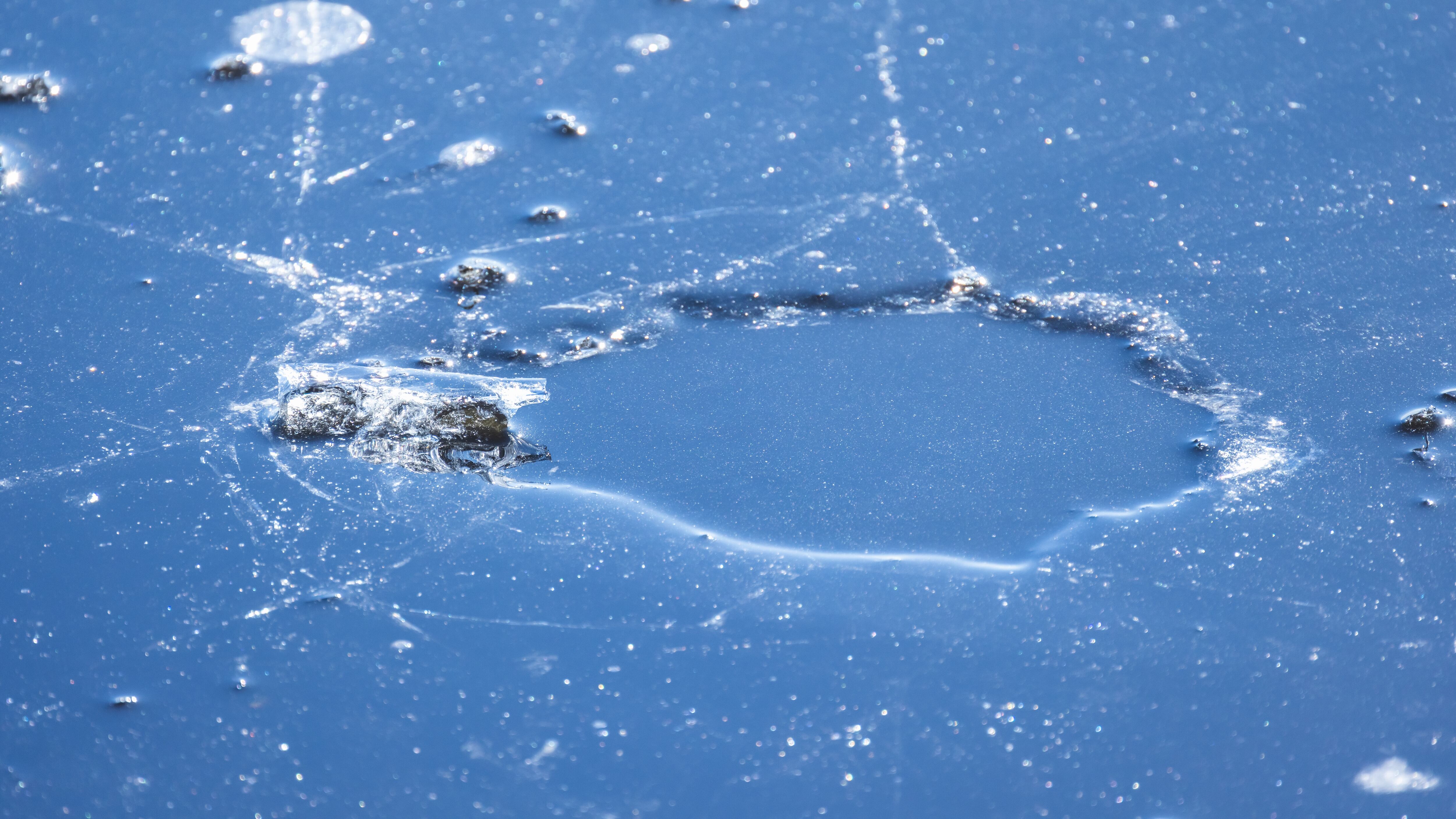 Frozen surface with a hole in thin ice