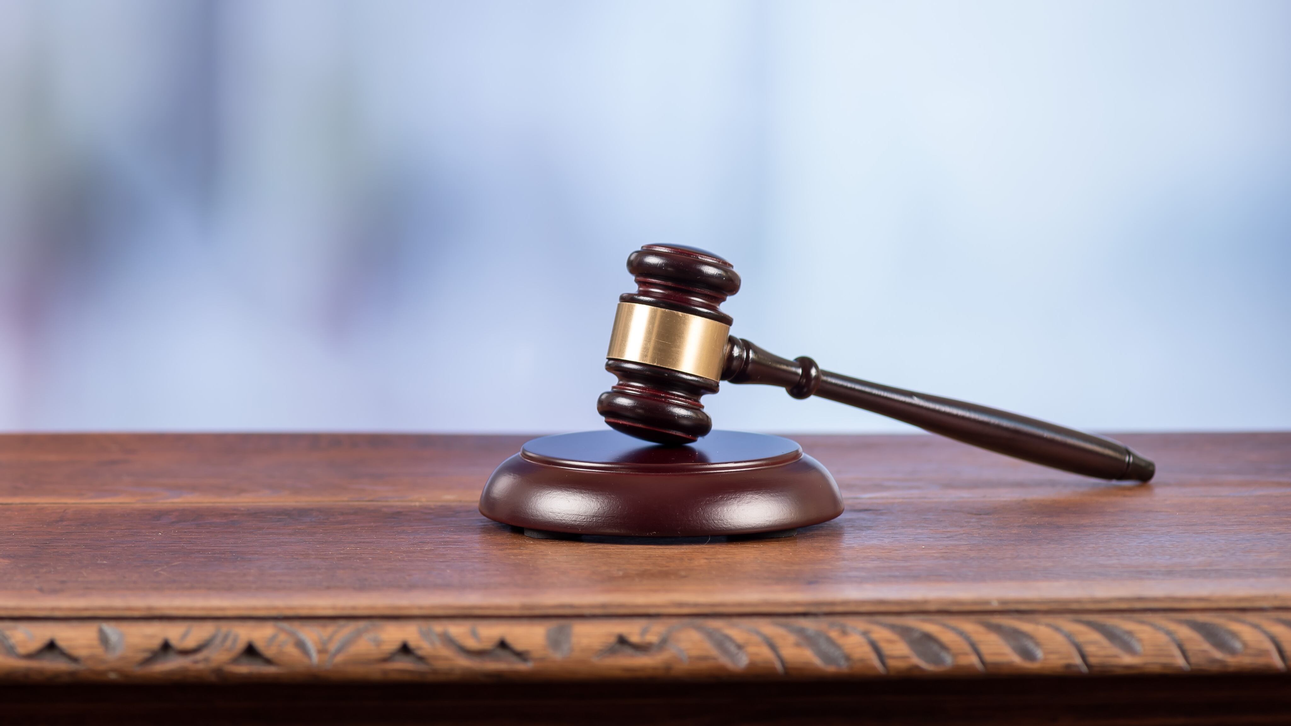 A gavel on an old desk on a blurred background