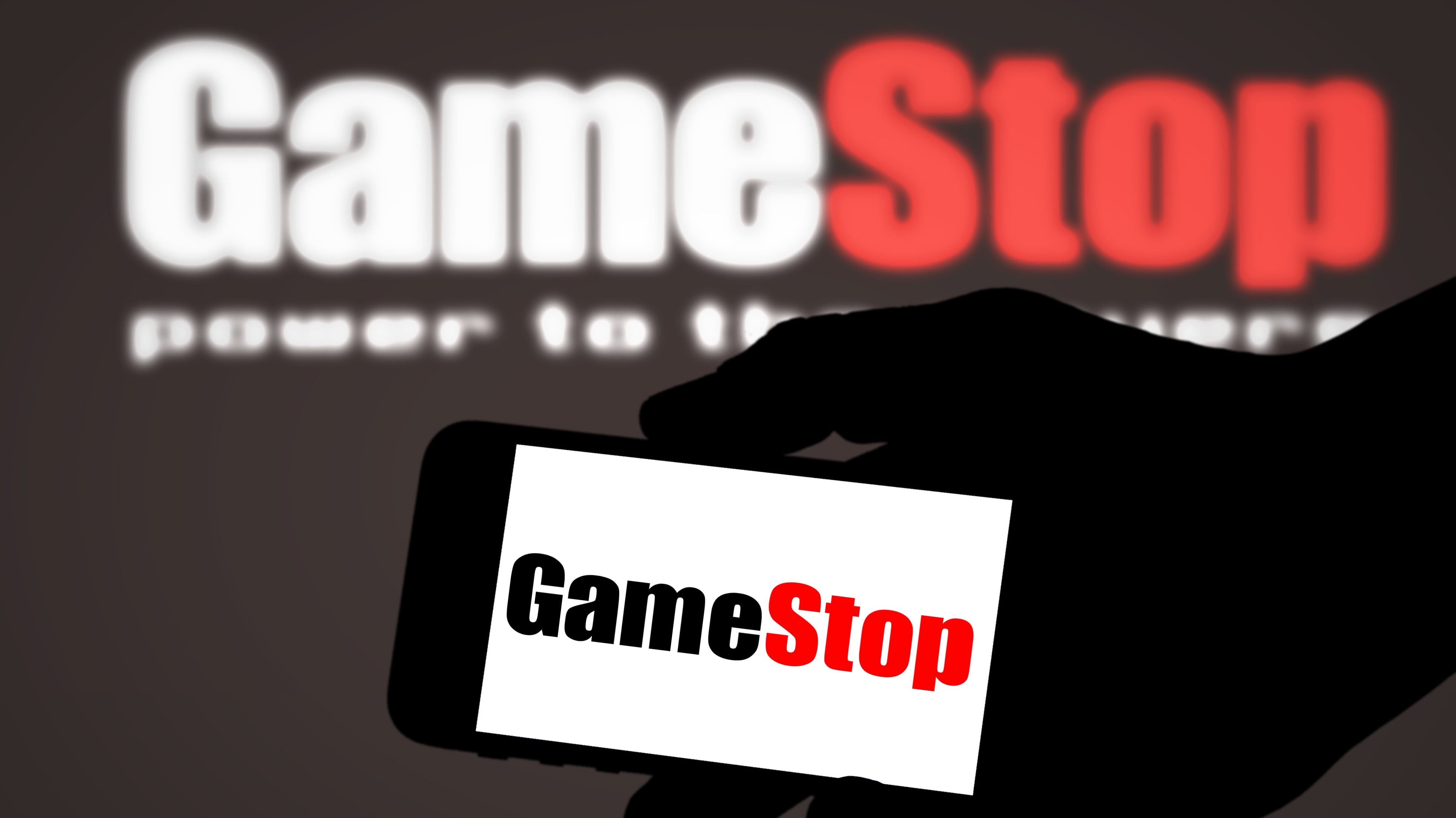 GameStop company logo on a cellphone and background
