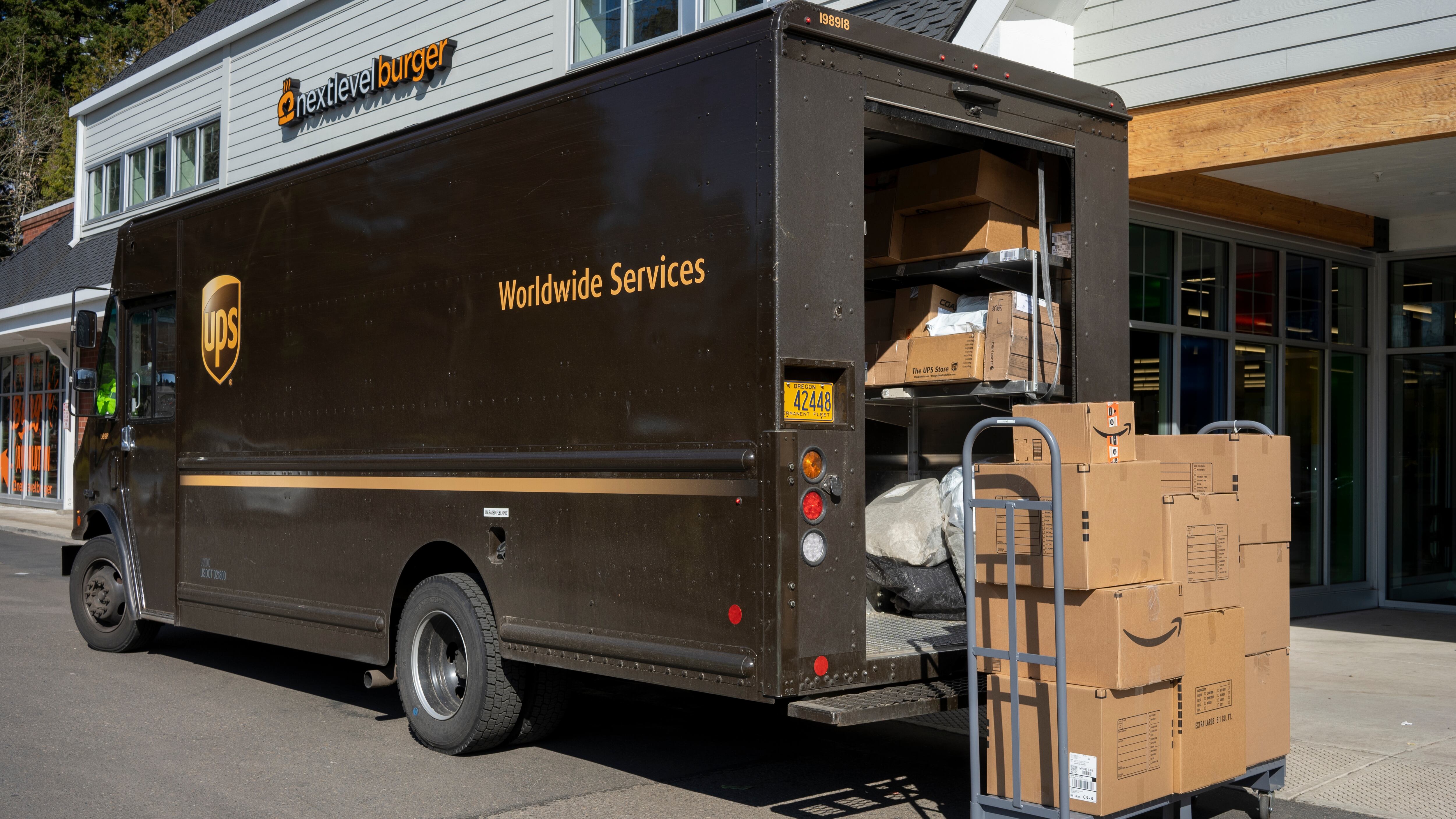 UPS truck and packages on a city street.