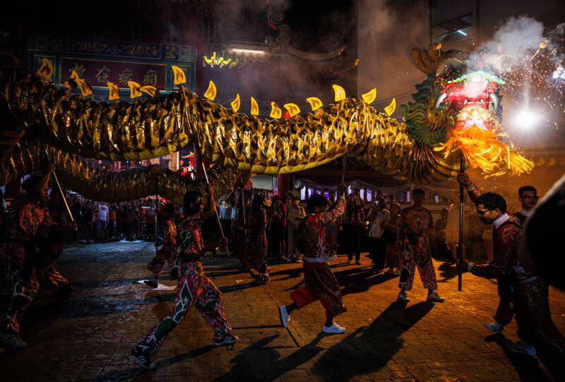 BANGKOK, THAILAND - FEBRUARY 09: A dragon dance troupe performs at the Kuan Yim Shrine in Chinatown on Lunar New Years Eve on February 09, 2024 in Bangkok, Thailand. The Chinese diaspora of Southeast Asia celebrates a lively Lunar New Year in Bangkok's Chinatown. It is traditionally a time for people to meet their relatives and take part in celebrations with families. In Thailand, which has a sizeable population of Chinese lineage, people gather with family and celebrate with feasts and visits to temples. The Tourism Authority of Thailand is expecting a steep increase in tourism during the Lunar New Year now that visa free travel is permmited for Chinese citizens to Thailand. (Photo by Lauren DeCicca/Getty Images)