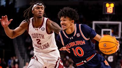 Auburn guard Chad Baker-Mazara (10) drives past South Carolina guard Zachary Davis (2) during the first half of an NCAA college basketball game on Saturday, Jan. 11, 2025, in Columbia, S.C. (AP Photo/Scott Kinser)